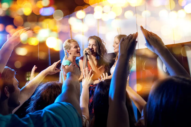 Karaoke-Auftritt mit jubelndem Publikum auf einer Firmenfeier